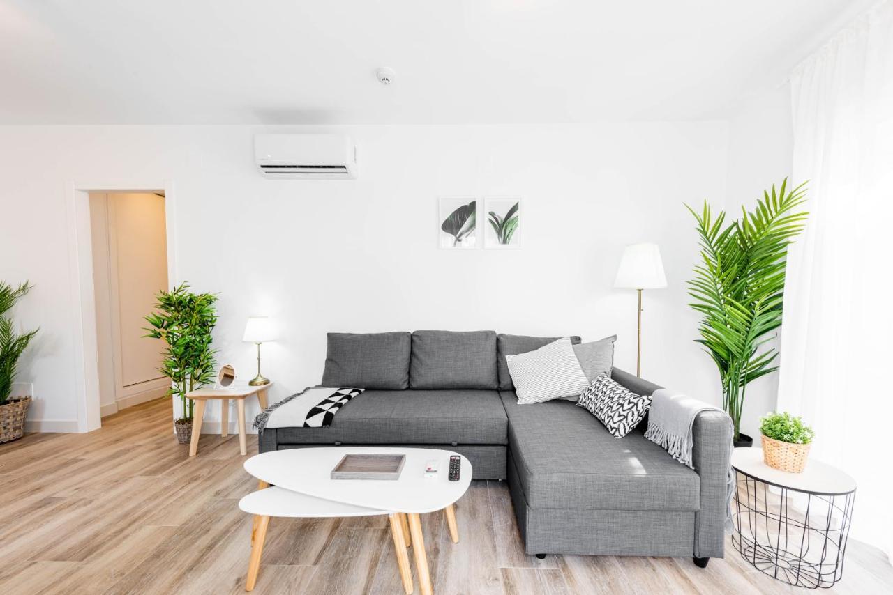Apartamentos Toboso Plaza Nerja Exterior photo A living room with a sofa