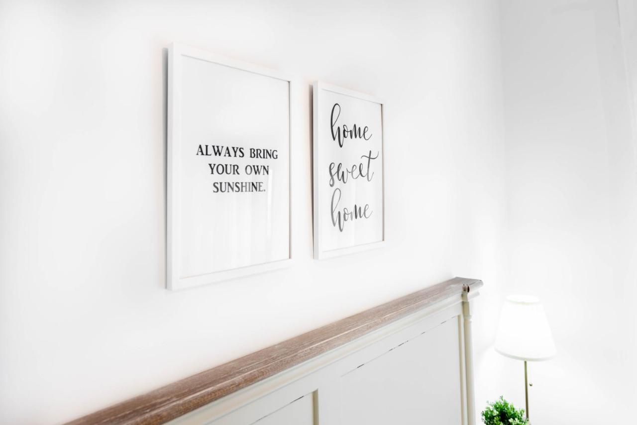 Apartamentos Toboso Plaza Nerja Exterior photo A wall decorated with two framed prints